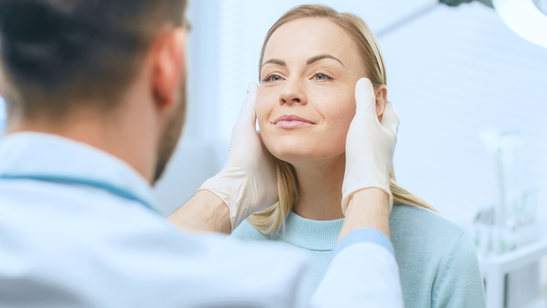 Plastic / Cosmetic Surgeon Examines Beautiful Woman's Face, Touches it with Gloved Hands, Inspecting Healed Face after Plastic Surgery with Amazing Results.